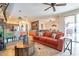 Living room with orange couch, coffee table, and view into kitchen at 17581 W Canyon Ln, Goodyear, AZ 85338