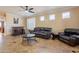 Spacious living room with leather furniture, a coffee table, and a home bar at 17581 W Canyon Ln, Goodyear, AZ 85338