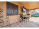 Covered patio with seating and a tv at 17581 W Canyon Ln, Goodyear, AZ 85338