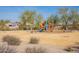 Community playground with playset and wood chips at 17581 W Canyon Ln, Goodyear, AZ 85338