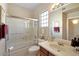 Bright bathroom featuring a shower-over-tub and modern fixtures and finishes at 17906 N Encanto Dr, Surprise, AZ 85374