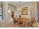 Cozy dining room featuring a wooden table with seating for six, a chandelier, and elegant decor at 17906 N Encanto Dr, Surprise, AZ 85374