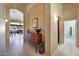 Inviting hallway featuring tile flooring, decorative niches, arched doorways, and views into the living spaces at 17906 N Encanto Dr, Surprise, AZ 85374