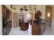 Kitchen with dark wood cabinets, granite counters, and island at 17906 N Encanto Dr, Surprise, AZ 85374