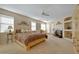 Serene main bedroom retreat with plush bedding, fireplace, and ample natural light at 17906 N Encanto Dr, Surprise, AZ 85374