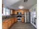 Renovated kitchen with stainless steel appliances and wood cabinets at 2118 E Oak St, Phoenix, AZ 85006