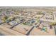 Aerial perspective of a desert property showcasing a solar-paneled house with a pool and RV parking at 22717 W Sierra Ridge Way, Wittmann, AZ 85361