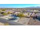 Aerial view of the residence with circle driveway, desert landscaping and neighboring homes at 22717 W Sierra Ridge Way, Wittmann, AZ 85361