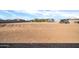 Expansive back lot primed for development with desert landscaping, space for parking and utilities at 22717 W Sierra Ridge Way, Wittmann, AZ 85361