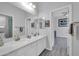 Bathroom featuring a double vanity with white cabinets and a quartz countertop at 22717 W Sierra Ridge Way, Wittmann, AZ 85361