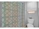 Bathroom with a toilet and a shower behind a decorative shower curtain at 22717 W Sierra Ridge Way, Wittmann, AZ 85361