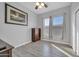 Bedroom with light gray walls, wood-look floors, a ceiling fan, and two windows at 22717 W Sierra Ridge Way, Wittmann, AZ 85361