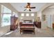 Bright bedroom features wood furniture, neutral walls, and large windows at 22717 W Sierra Ridge Way, Wittmann, AZ 85361