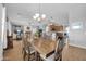 Open-concept dining area showcases a large wooden table and chairs, flowing into the living space at 22717 W Sierra Ridge Way, Wittmann, AZ 85361