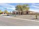 Charming single-story home with desert landscaping and mature shade tree at 22717 W Sierra Ridge Way, Wittmann, AZ 85361