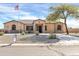 Charming single-story home with desert landscaping and a paved driveway, set against a beautiful blue sky at 22717 W Sierra Ridge Way, Wittmann, AZ 85361