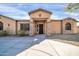 Close-up of a front exterior with stone accents and landscaped yard at 22717 W Sierra Ridge Way, Wittmann, AZ 85361