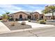 Charming single-story home with desert landscaping and a curved paved driveway, set against a beautiful blue sky at 22717 W Sierra Ridge Way, Wittmann, AZ 85361