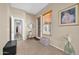 Hallway featuring tile flooring, a decorative clock, and plenty of natural light at 22717 W Sierra Ridge Way, Wittmann, AZ 85361