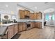 Well-equipped kitchen with wood cabinets, stainless steel appliances, and breakfast bar at 22717 W Sierra Ridge Way, Wittmann, AZ 85361