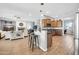 Open-concept kitchen with island, modern appliances, and adjacent living area at 22717 W Sierra Ridge Way, Wittmann, AZ 85361