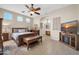 Spacious bedroom with tile flooring, a ceiling fan, and an en-suite bathroom with dual sinks at 22717 W Sierra Ridge Way, Wittmann, AZ 85361