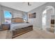 Serene bedroom with a neutral color scheme, large bed frame, and an en-suite bathroom at 22717 W Sierra Ridge Way, Wittmann, AZ 85361