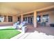 Covered patio with comfortable lounge chairs, a ceiling fan, and a dining area at 22717 W Sierra Ridge Way, Wittmann, AZ 85361