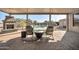 Covered patio with cushioned chairs, a fireplace, and a view of the pool at 22717 W Sierra Ridge Way, Wittmann, AZ 85361