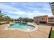 Sparkling blue swimming pool with surrounding desert landscaping, shed and a concrete patio at 22717 W Sierra Ridge Way, Wittmann, AZ 85361