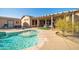 Sparkling swimming pool surrounded by a patio and an outdoor seating area at 22717 W Sierra Ridge Way, Wittmann, AZ 85361