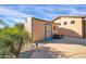 Backyard view of the storage shed with desert landscaping including palm trees and a concrete walkway at 22717 W Sierra Ridge Way, Wittmann, AZ 85361