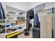 Spacious walk-in closet with shelving and hanging rods for efficient organization at 22717 W Sierra Ridge Way, Wittmann, AZ 85361