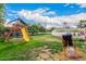 Large backyard featuring a playground, green lawn, and a safety-fenced pool area, great for Gathering fun at 2401 E Christy Dr, Phoenix, AZ 85028