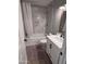 Updated bathroom with marble-tiled tub and vanity at 2401 E Christy Dr, Phoenix, AZ 85028