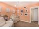 Bedroom with a crib, chair, peach color palette, and natural light at 2401 E Christy Dr, Phoenix, AZ 85028