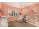 Bedroom with a neutral color palette, crib, and natural light at 2401 E Christy Dr, Phoenix, AZ 85028