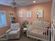 Bright Bedroom with crib, armchair, and shelves at 2401 E Christy Dr, Phoenix, AZ 85028