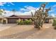 Charming single-story home with desert landscaping and a two-car garage at 2401 E Christy Dr, Phoenix, AZ 85028