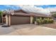 Attached two-car garage with matching brown door and a basketball hoop in the driveway at 2401 E Christy Dr, Phoenix, AZ 85028