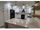 Modern kitchen with white cabinets, granite countertops, and black appliances at 2401 E Christy Dr, Phoenix, AZ 85028