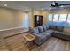 Comfortable living room featuring a grey sectional sofa and hardwood floors at 2401 E Christy Dr, Phoenix, AZ 85028