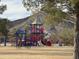 A colorful playground structure featuring slides, climbing areas, and shaded seating for enjoyment at 2401 E Christy Dr, Phoenix, AZ 85028