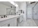 Elegant bathroom with double vanity, large shower, and marble tile at 25232 S Pyrenees Ct, Queen Creek, AZ 85142