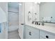 Bright bathroom with white vanity, black fixtures, and marble tile at 25232 S Pyrenees Ct, Queen Creek, AZ 85142