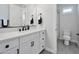 Clean bathroom with white vanity, black fixtures, and gray tile at 25232 S Pyrenees Ct, Queen Creek, AZ 85142