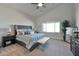 Spacious bedroom with king-size bed and large window at 25232 S Pyrenees Ct, Queen Creek, AZ 85142