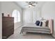 Serene bedroom with a dresser, a bed, and arched window at 25232 S Pyrenees Ct, Queen Creek, AZ 85142