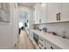 Butler's pantry with white cabinets, quartz countertops and built-in microwave at 25232 S Pyrenees Ct, Queen Creek, AZ 85142