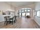 Bright dining room with a glass-top table and chandelier at 25232 S Pyrenees Ct, Queen Creek, AZ 85142